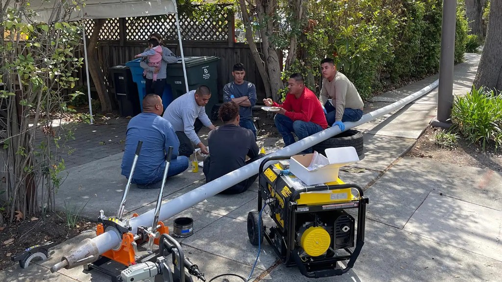 Utility crew on a residential job site in the Bay Area, equipment and pipe fusion tools in the foreground
